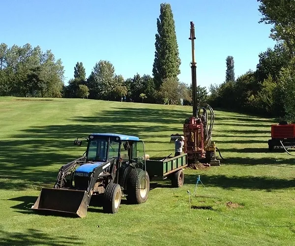 A bore hole driller starting to drill on a golfcourse