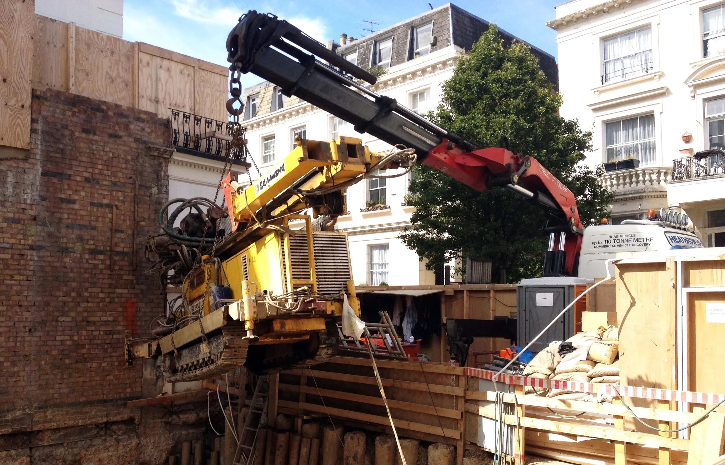 Drilling rig being lowered into a London basement